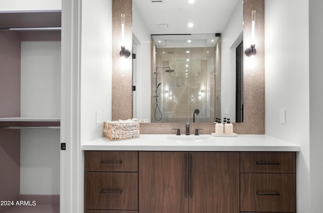 bathroom featuring vanity and a shower with shower door