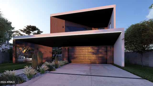 view of front of property with a garage and a carport