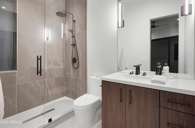 bathroom featuring walk in shower, vanity, and toilet