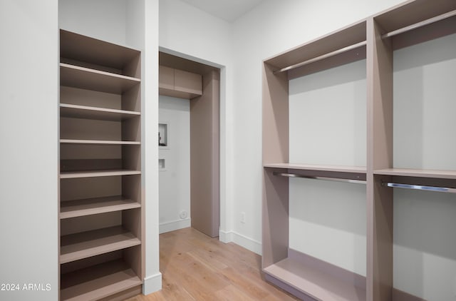 spacious closet featuring light hardwood / wood-style flooring