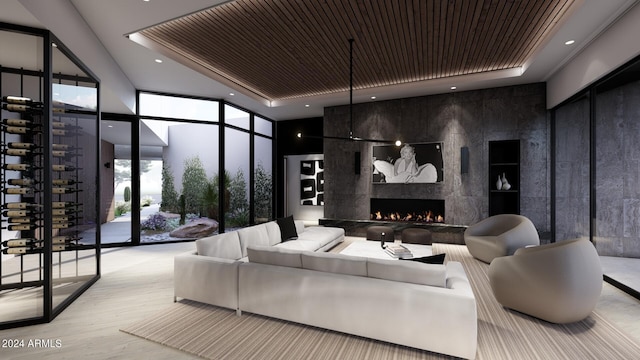 interior space featuring light hardwood / wood-style flooring, a wall of windows, a fireplace, and wooden ceiling