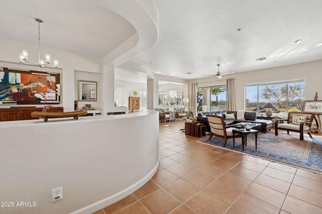 reception featuring ceiling fan with notable chandelier