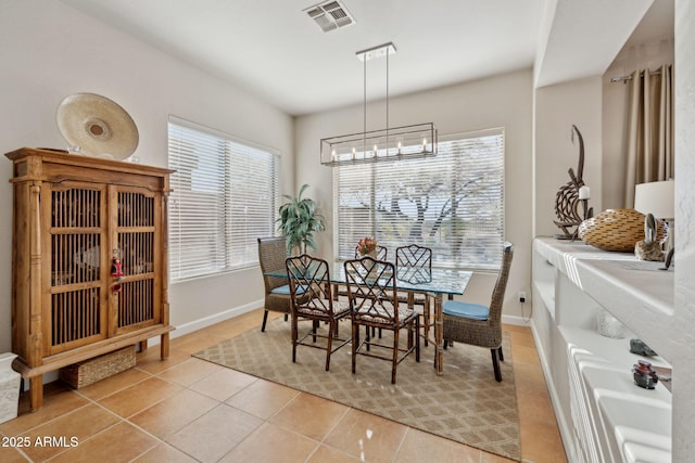 tiled dining space featuring a chandelier