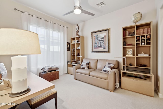 carpeted living room with ceiling fan