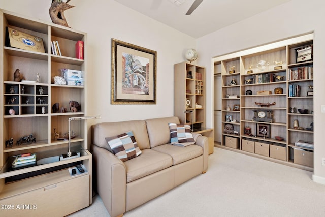 living area featuring ceiling fan and carpet flooring