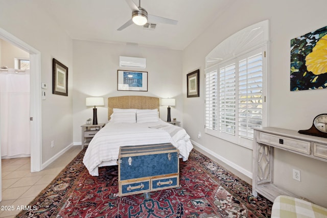 bedroom with light tile patterned floors, an AC wall unit, and ceiling fan