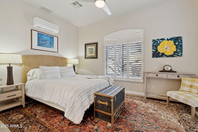 bedroom with a wall unit AC and ceiling fan