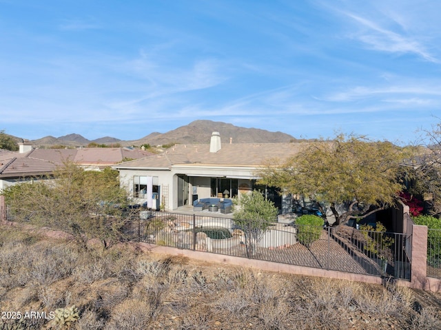 exterior space with a mountain view and a patio area