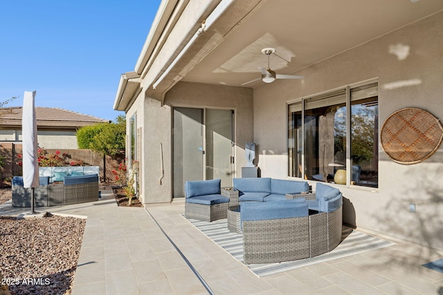 view of patio / terrace with ceiling fan and an outdoor living space