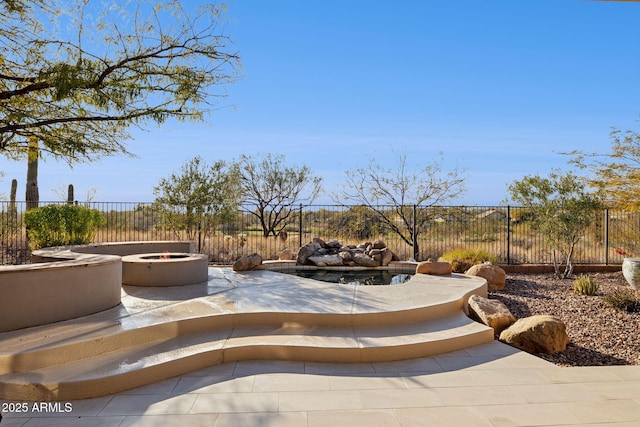 view of patio with a fire pit