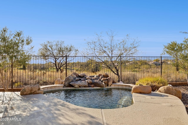 view of swimming pool featuring pool water feature and a patio area