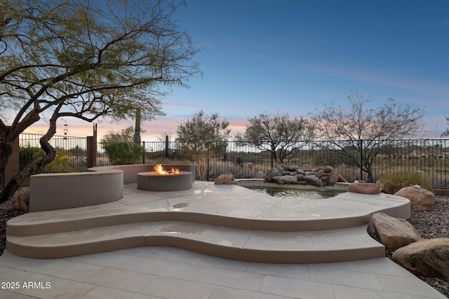 surrounding community featuring a patio area and an outdoor fire pit