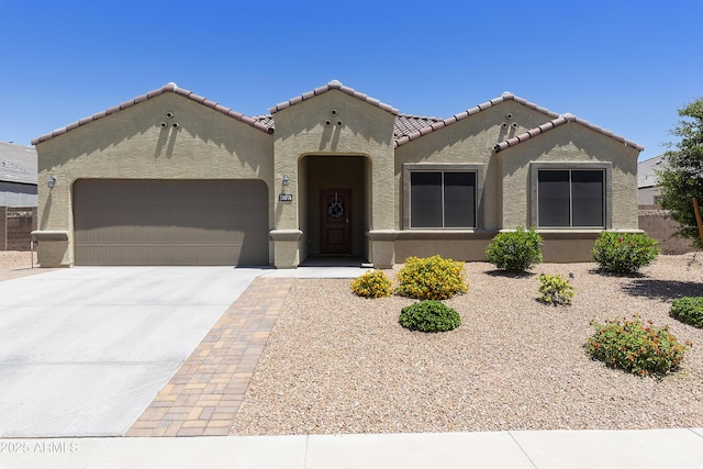 30776 W Earll Dr, Buckeye, AZ 85396 - mediterranean / spanish home with an attached garage, concrete driveway, stucco siding, and a tiled roof