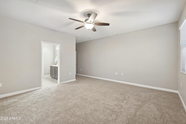 30776 W Earll Dr, Buckeye, AZ 85396 - spare room featuring a ceiling fan, light carpet, and baseboards