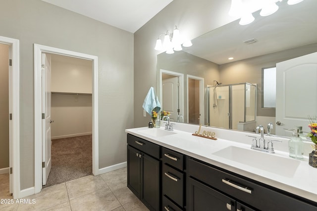 30776 W Earll Dr, Buckeye, AZ 85396 - full bath featuring a stall shower, baseboards, tile patterned flooring, and a walk in closet