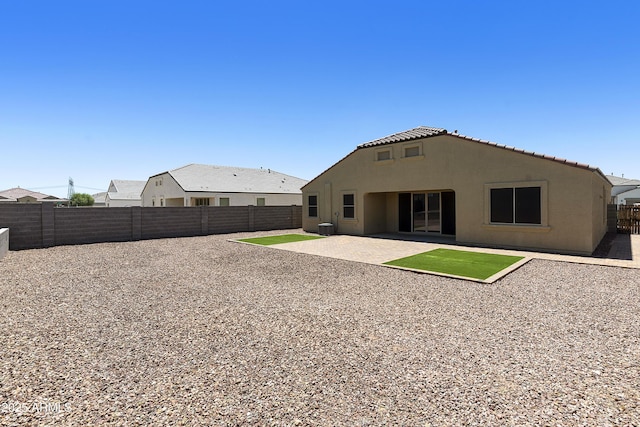 30776 W Earll Dr, Buckeye, AZ 85396 - rear view of property featuring a fenced backyard, stucco siding, a patio area, and a tile roof