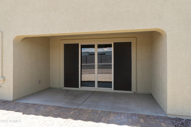 30776 W Earll Dr, Buckeye, AZ 85396 - view of exterior entry with stucco siding and a patio