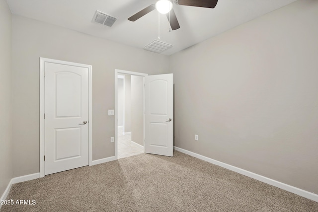 30776 W Earll Dr, Buckeye, AZ 85396 - unfurnished bedroom featuring light carpet, baseboards, and ceiling fan