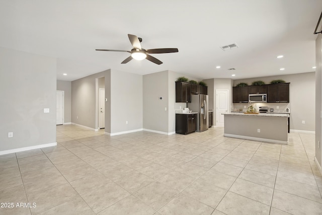 30776 W Earll Dr, Buckeye, AZ 85396 - unfurnished living room with light tile patterned floors, a ceiling fan, recessed lighting, and baseboards