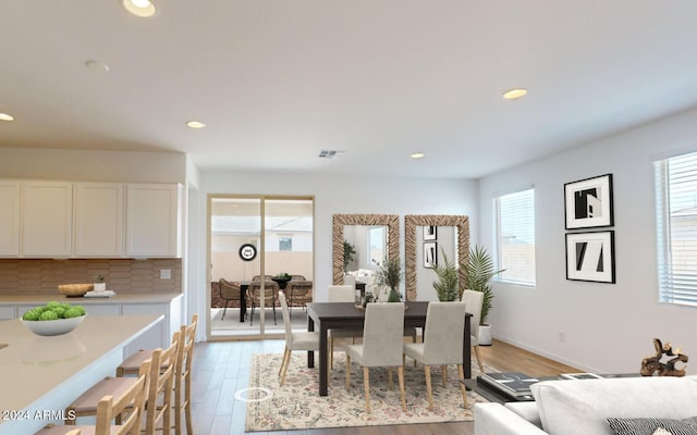 dining room featuring light wood-type flooring, recessed lighting, and visible vents
