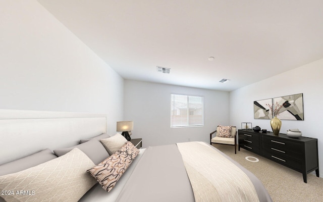 bedroom with visible vents and light carpet