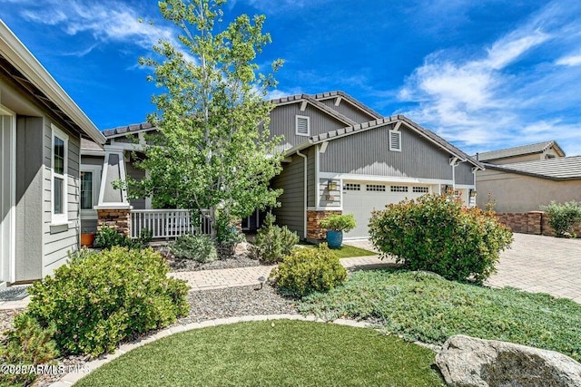 craftsman-style house featuring a garage and covered porch