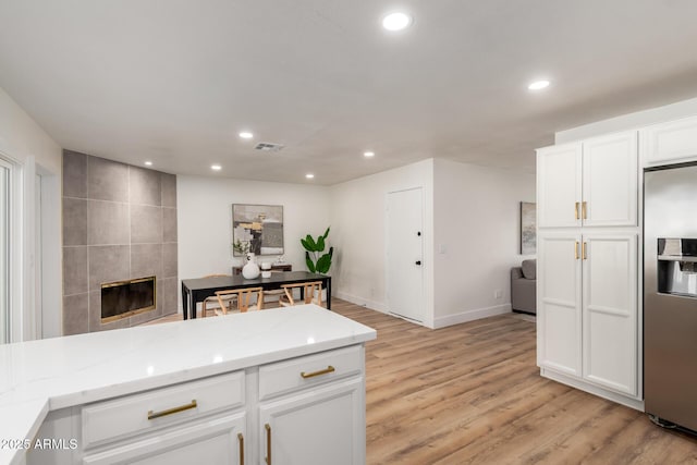 510 N Entrada St, Chandler, AZ 85226 - kitchen with stainless steel fridge with ice dispenser, recessed lighting, light stone countertops, white cabinets, and light wood-style floors
