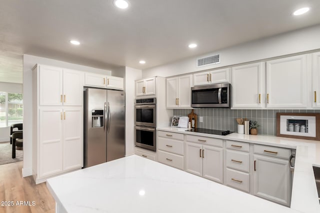 510 N Entrada St, Chandler, AZ 85226 - kitchen with appliances with stainless steel finishes, white cabinetry, decorative backsplash, recessed lighting, and light stone countertops