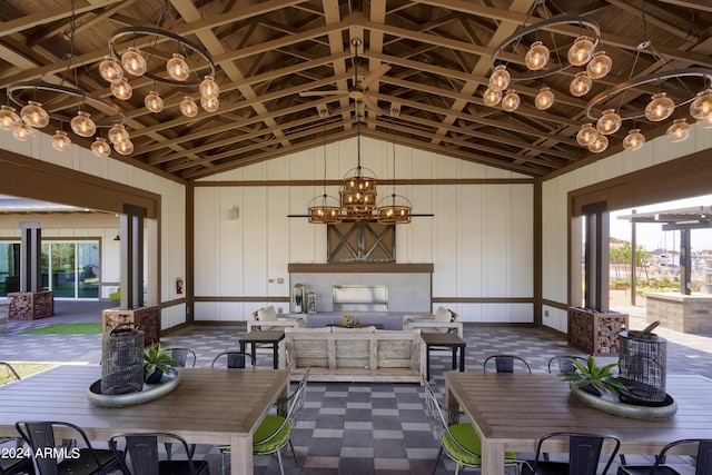 dining room featuring an inviting chandelier and vaulted ceiling