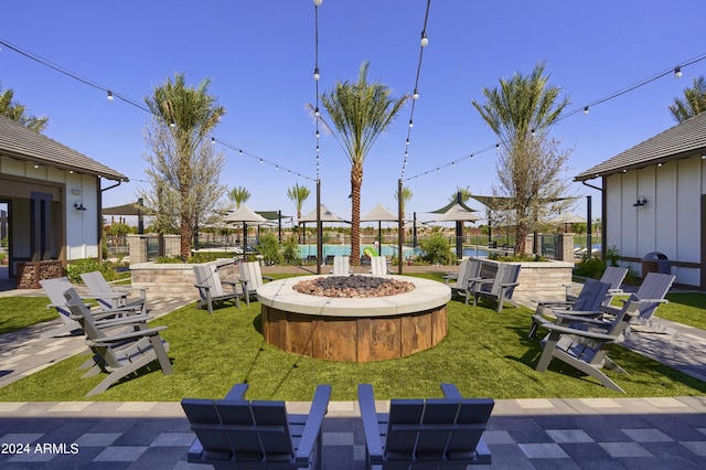 view of yard with a fire pit and fence