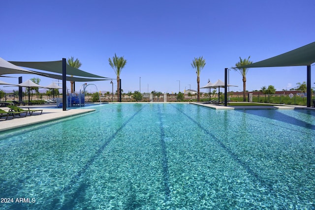 pool with a patio and fence