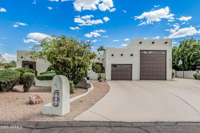 9035 W Villa Chula, Peoria, AZ 85383 - pueblo-style house featuring a garage, stucco siding, and driveway