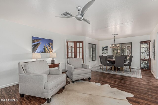 9035 W Villa Chula, Peoria, AZ 85383 - living area featuring baseboards, visible vents, wood finished floors, and ceiling fan with notable chandelier