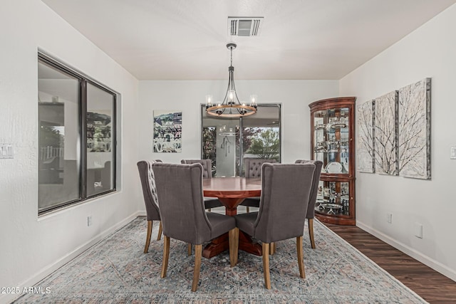 9035 W Villa Chula, Peoria, AZ 85383 - dining space featuring an inviting chandelier, baseboards, wood finished floors, and visible vents