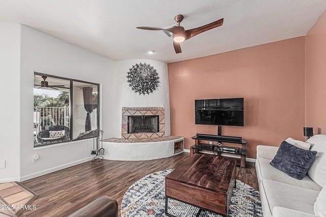 9035 W Villa Chula, Peoria, AZ 85383 - living room with baseboards, a ceiling fan, wood finished floors, and a fireplace