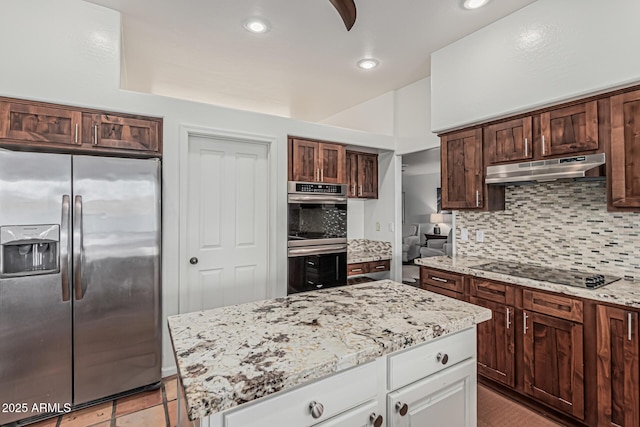 9035 W Villa Chula, Peoria, AZ 85383 - kitchen with backsplash, light stone counters, under cabinet range hood, stainless steel appliances, and white cabinetry