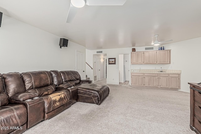 9035 W Villa Chula, Peoria, AZ 85383 - living room with light colored carpet, baseboards, ceiling fan, and visible vents