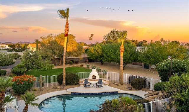 9035 W Villa Chula, Peoria, AZ 85383 - view of pool featuring a patio, a fenced in pool, exterior fireplace, and a fenced backyard
