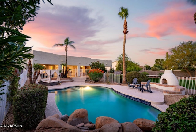 9035 W Villa Chula, Peoria, AZ 85383 - pool at dusk with fence, a fenced in pool, and a patio area