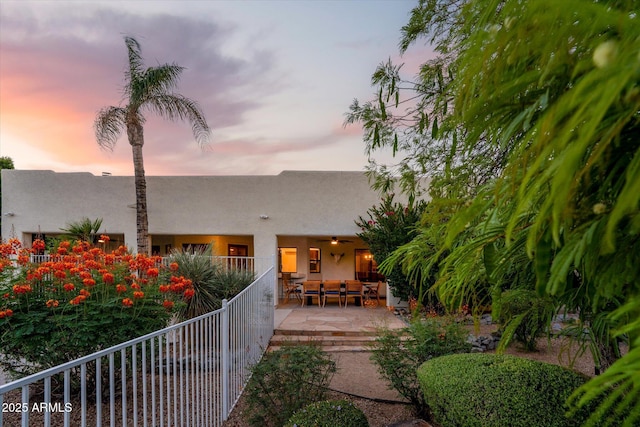 9035 W Villa Chula, Peoria, AZ 85383 - rear view of property featuring fence, stucco siding, an outdoor living space, and a patio area