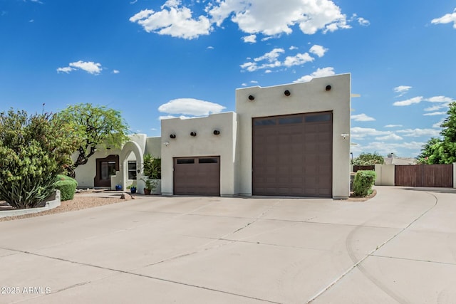 9035 W Villa Chula, Peoria, AZ 85383 - pueblo revival-style home featuring a garage, stucco siding, driveway, and fence