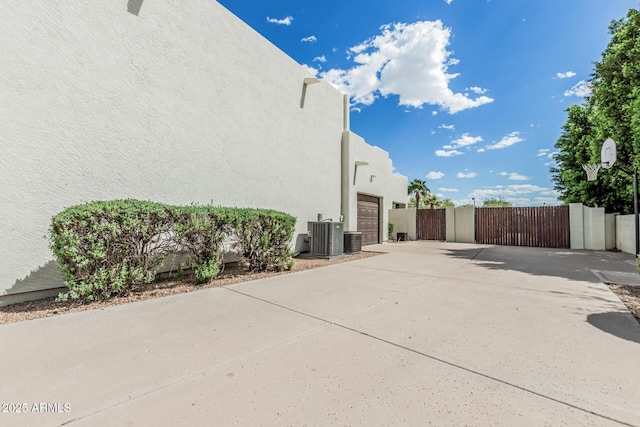 9035 W Villa Chula, Peoria, AZ 85383 - view of side of property with fence, an attached garage, stucco siding, a gate, and concrete driveway