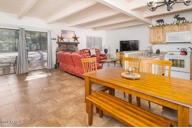 2868 Park Cir Unit 38, Pinetop, AZ 85935 - dining space featuring beam ceiling, sink, a chandelier, and a fireplace