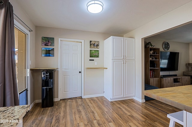 kitchen featuring white cabinetry and wood-type flooring