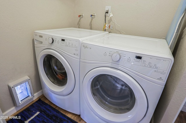 laundry room with independent washer and dryer and dark hardwood / wood-style floors