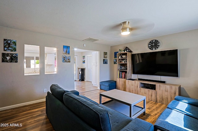 living room featuring wood-type flooring and ceiling fan