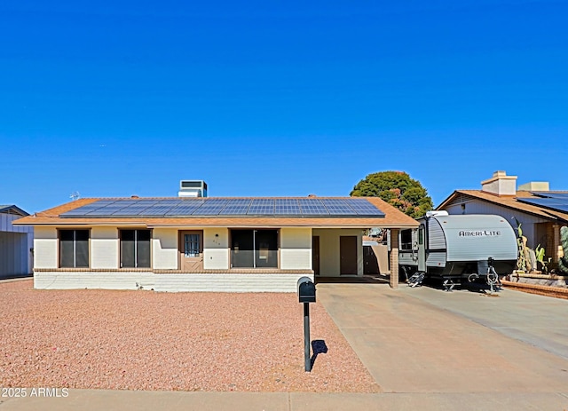 view of front of property featuring solar panels