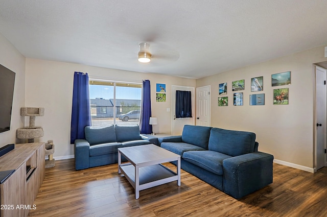 living room with dark hardwood / wood-style floors and ceiling fan