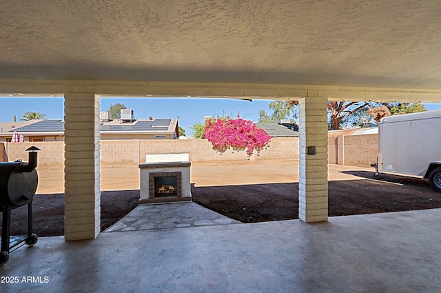 view of patio with grilling area and exterior fireplace