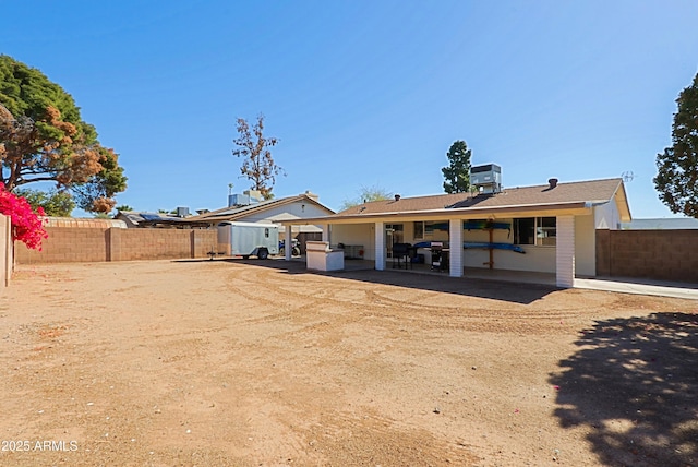 rear view of house with central AC and a patio area